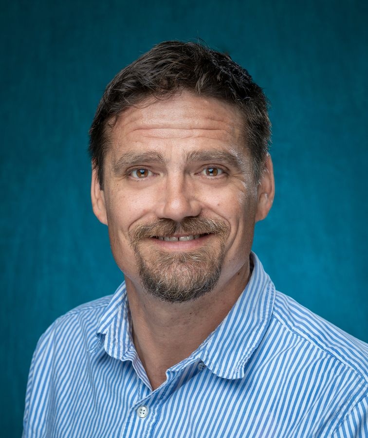 Male faculty member smiling in portrait