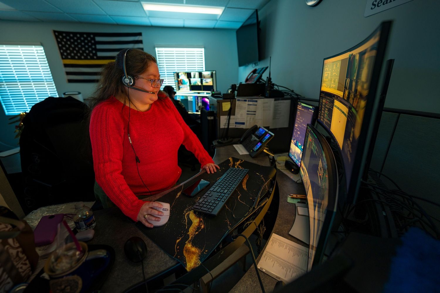 UNCW Dispatch operator at desk with computers.